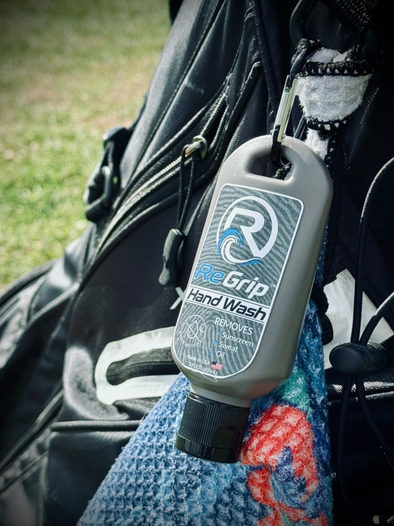 ReGrip hand wash clipped to a golf bag beside a towel